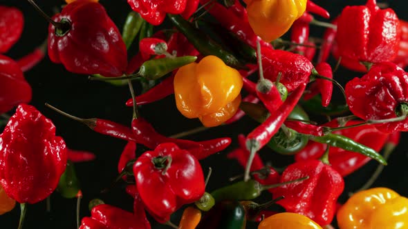 Super Slow Motion Shot of Flying Mixed Chilli Peppers Towards Camera at 1000Fps alt
