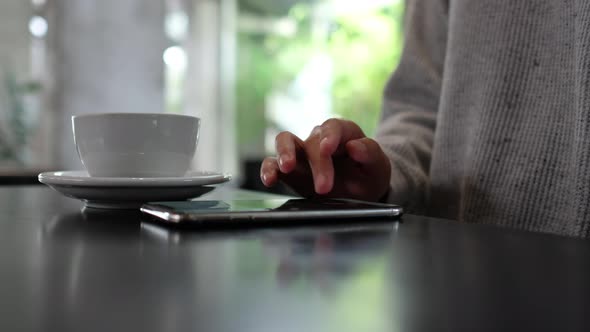 Closeup of a woman touching and scrolling on smart phone screen