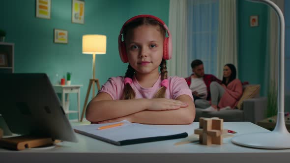 Portrait of Schoolgirl Sitting at Desk at Home alt