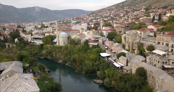 Aerial shot of Stari Most, old bridge, in Mostar. the camera slowly pulls back to reveal Stari Most alt