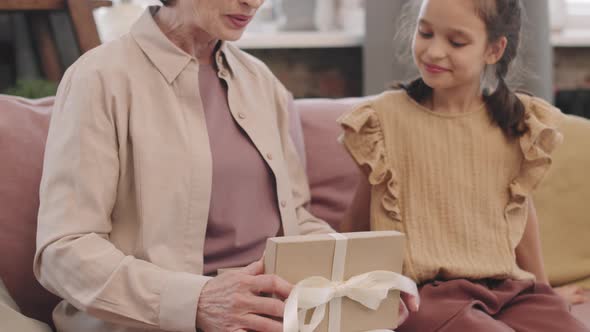 Mature Woman Opening Present From Granddaughter alt