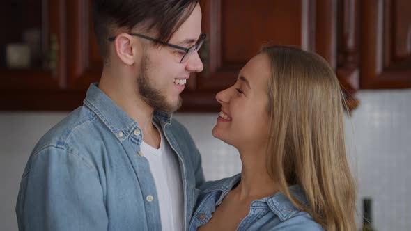Closeup of Happy Caucasian Young Couple Looking at Each Other with Love Turning to Camera Smiling alt
