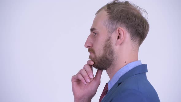 Profile View of Happy Bearded Businessman Thinking