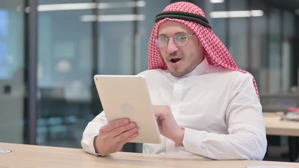 Successful Middle Aged Arab Man Celebrating on Tablet alt