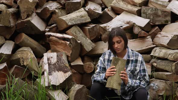 Woman in the Forest Near the Pole of Chopped Wood alt