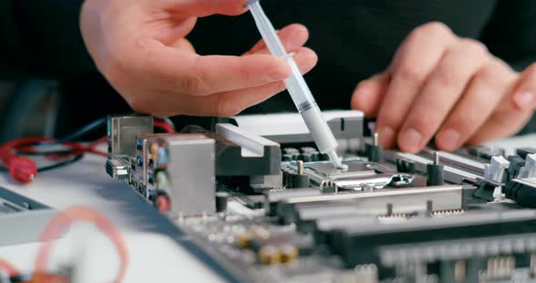 Close Up of Thermal Paste Application on CPU Micro Processor in PC Motherboard