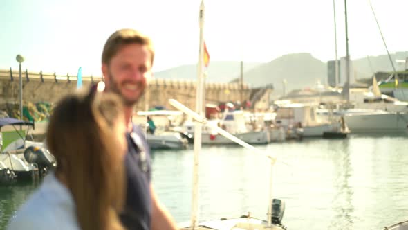 Young Couple Walking Along Port alt