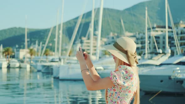 Young Blogger Shooting Video on Her Smartphone on the City Waterfront