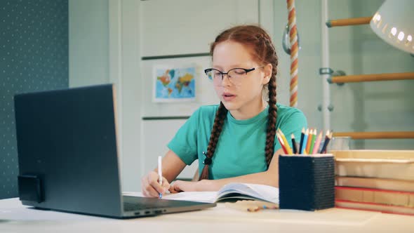 A Girl Is Studying Through the Internet in Her Room alt