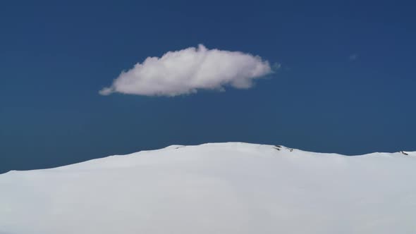 8K One Piece Cumulus Cloud in Blue Sky on Clear Snowy Land