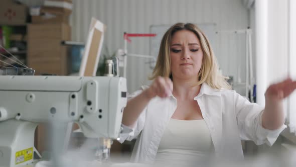 Young Beautiful Light Hair Seamstress Gets Angry in the Workplace