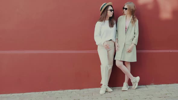 Two young beautiful women posing outdoors  alt