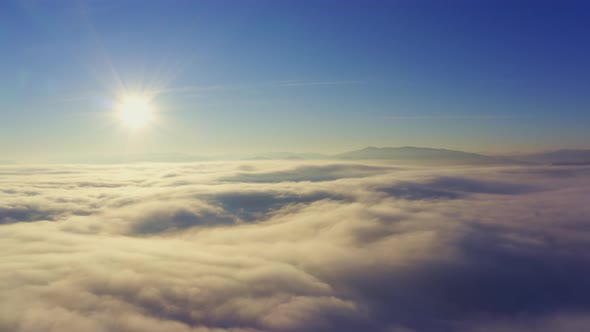 Wonderful View of Extraordinary Cloudy Valley and Bright Orange Sunset