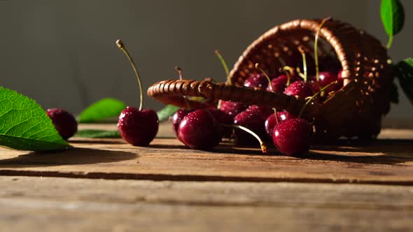 Ripe Cherries in a Small Basket Closeup on a Wooden Table
