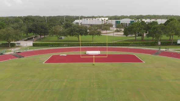 Drone flight through goal post on a high school football field - super smooth aerial alt