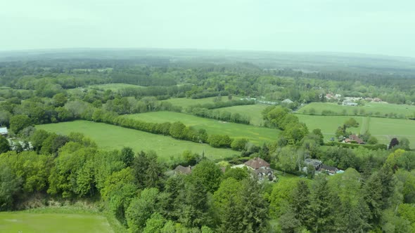 Aerial view over green patchwork farmland countryside pasture landscape alt