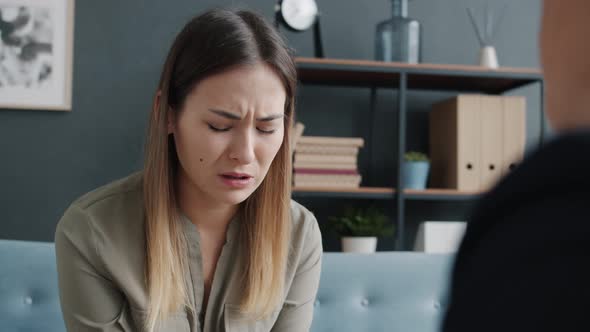 Portrait of Depressed Girl Crying and Complaining During Therapy Session with Female Specialist alt