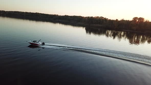  Motor Boat Floating on the River at Sunset