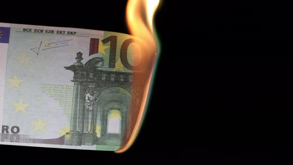 Burning Hundred Euros on a Black Background