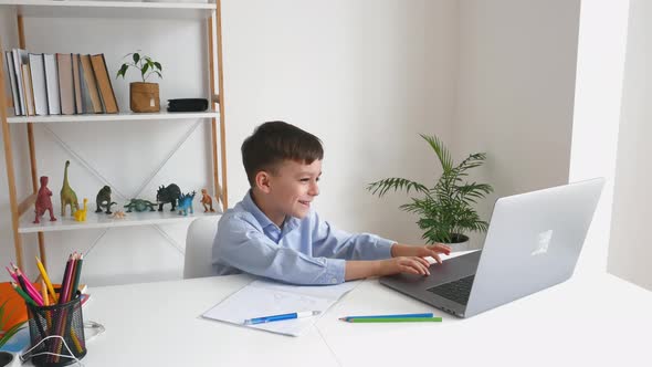 Kid Via Laptop Talking with Teacher During Online Studying at Home