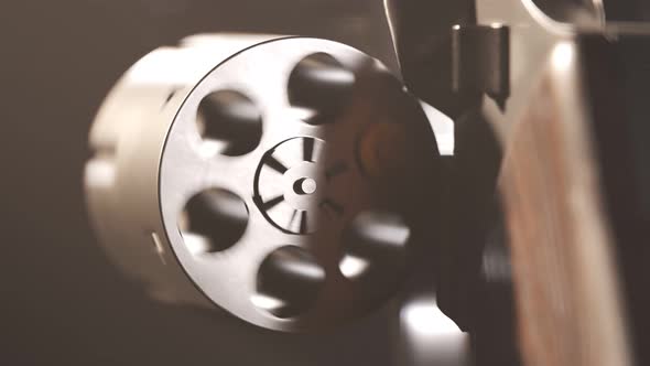 Spinning cylinder with one bullet. Playing russian roulette with a revolver. alt