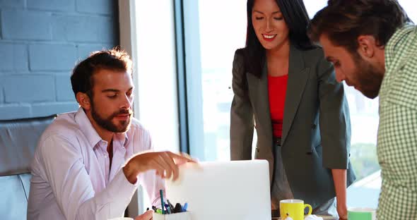 Businessman interacting with coworkers alt