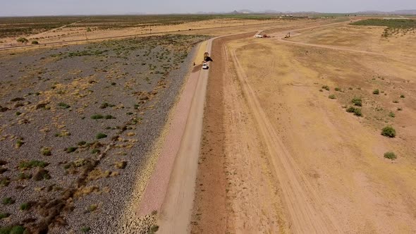 Drone shot of building a dirt wall or border for a rock quarry alt