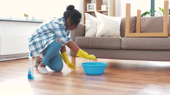 African Woman with Sponge Cleaning Floor at Home 38 alt