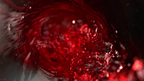 Super Slow Motion Abstract Shot of Red Wine Pouring in Glass Bottle at 1000 Fps. alt