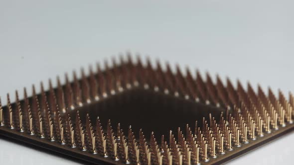 The Computer Processor CPU with Gold Plated Contacts Spins on White Background alt