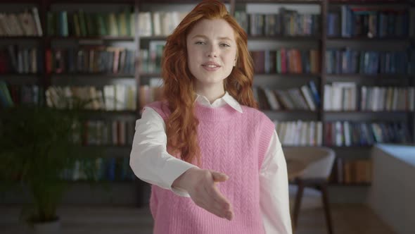 Smiling Confident Young Student Woman Employer Looking at Camera Extending Hand for Handshake Offer alt