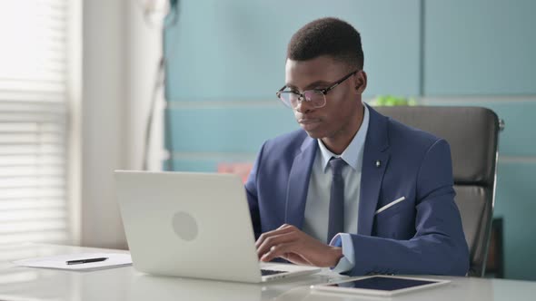 Young African Businessman with Laptop Shaking Head As Yes Sign alt