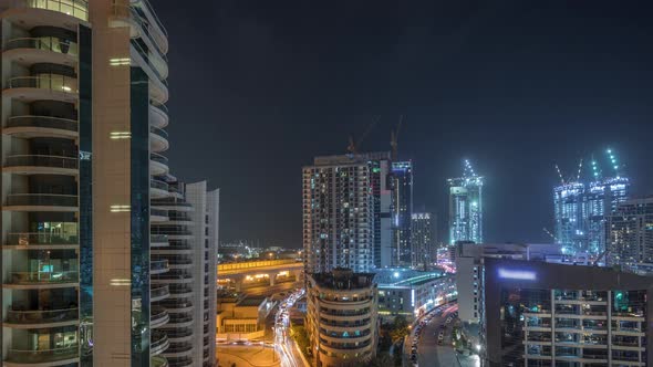 Dubai Marina Skyscrapers and Promenade Aerial Night Timelapse Dubai United Arab Emirates alt