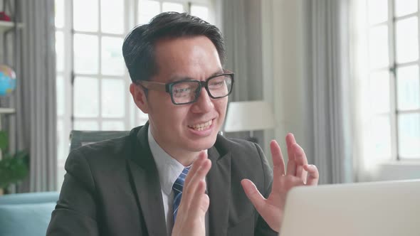 Asian Businessman Having A Video Call On Computer While Working At Home alt