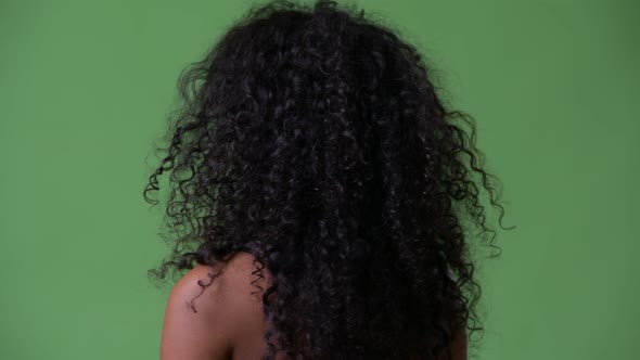 Young Beautiful Hispanic Woman with Gym Clothes Looking Back alt