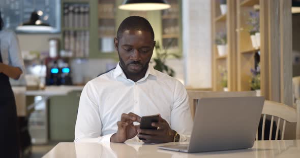 Waitress in Safety Mask Serve Coffee for Businessman in Restaurant alt