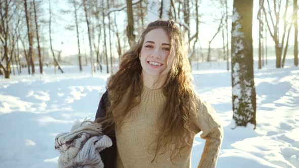 Attractive Young Girl in a Sweater Dresses a Jacket. Curly Young Woman in Warm Clothes on a alt