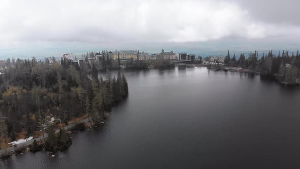 Aerial View of Strbske Pleso, Slovakia. Mountain Lake in Clouds and Snowy Tatras Mountains alt