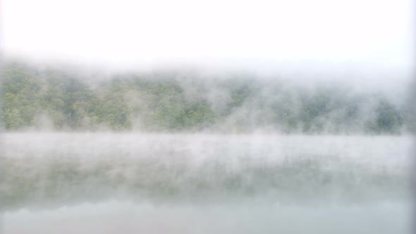 Fog over the forest with the river. Beautiful morning landscape. alt