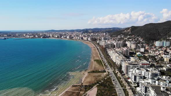 Drone Shot of the Beach in a Bright Day with Palm Trees and Blue Water alt