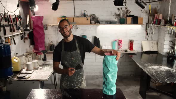 Portrait of a man, close-up: a man in glasses of Arab appearance looks at the workshop, thinks alt