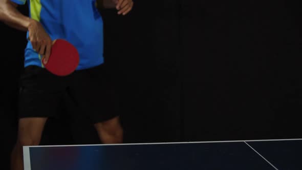 Young Male Playing Tennis On Black Background alt