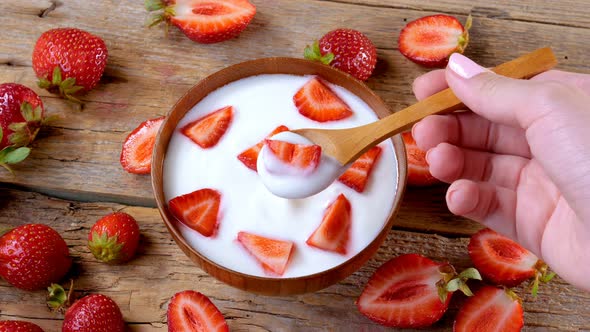 Eating Strawberries Yogurt from Bowl