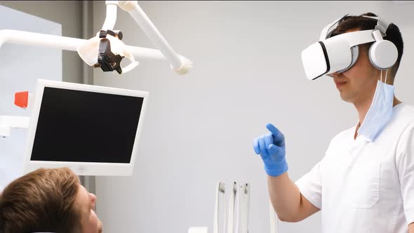 A Dentist in 3D Glasses Works with a Client in the Clinic of the Future alt
