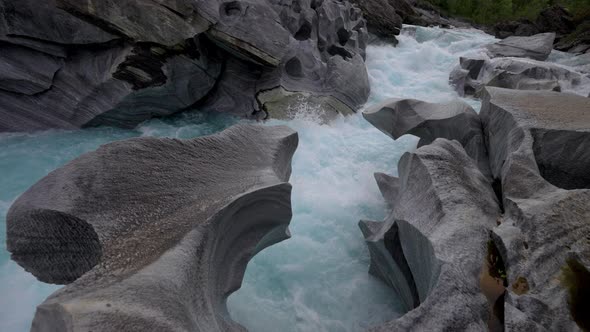 White river rapids along the rocks of the Marble Castle in Northern Norway -Wide alt