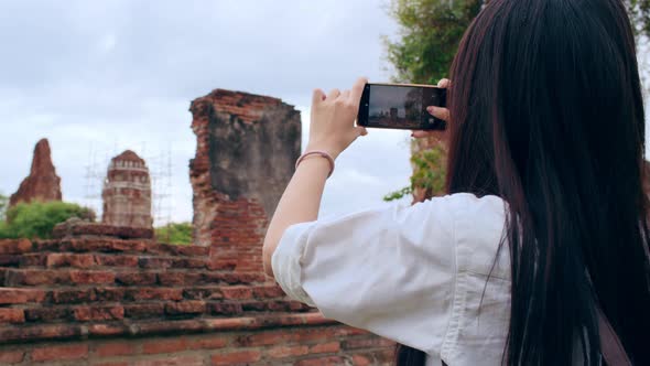 Japanese backpacker female enjoy her journey at amazing landmark in traditional city. alt