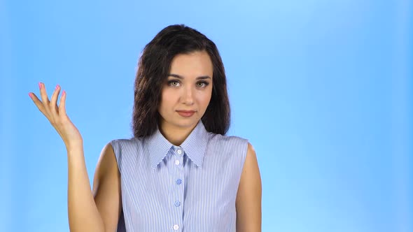 Woman Twisting Finger at a Temple Judging You Crazy. alt