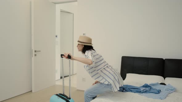 Woman Looking Around at Home and Leaving Apartment with Suitcase for Vacation alt