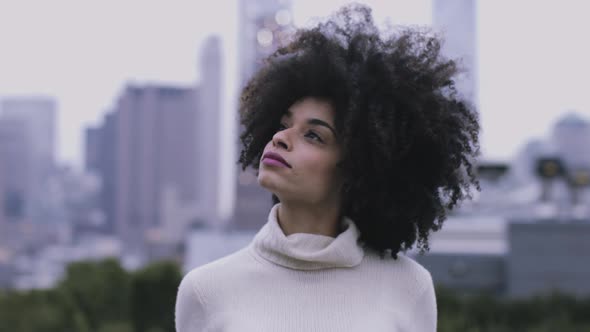 Portrait of Afro American Female on rooftop looking to camera, Manhattan - New York