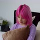 Depressed Pretty Pink Haired Woman Sitting on Bed with Upset Expression - VideoHive Item for Sale